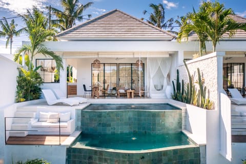 front view of the villa with the 2 infinity pools facing the view