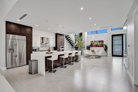 View of the gourmet kitchen, breakfast bar, and dining area.