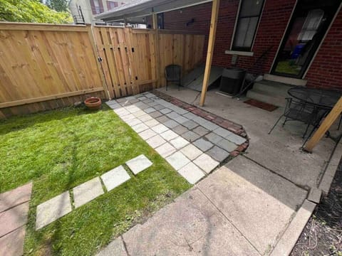 Fenced in yard area with a patio table and 4 chairs.
