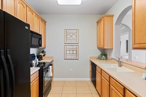 This fully equipped kitchen is a culinary haven, complete with modern appliances and ample space for preparing delicious meals.