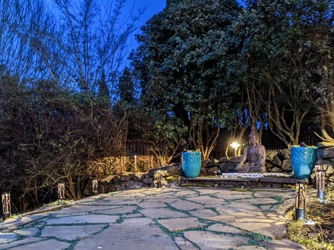Evening view of the property with warm outdoor lighting.