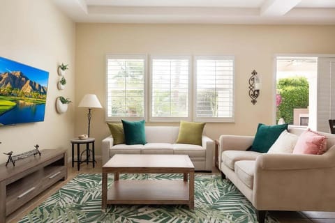 Bright living room area with lovely green accents.