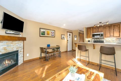 Sofa view to gas fireplace, dining area and kitchen.jpg