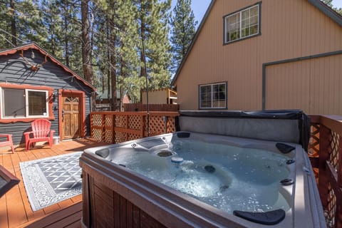 Large deck surrounded by pinecone trees and relaxing spa awaits!