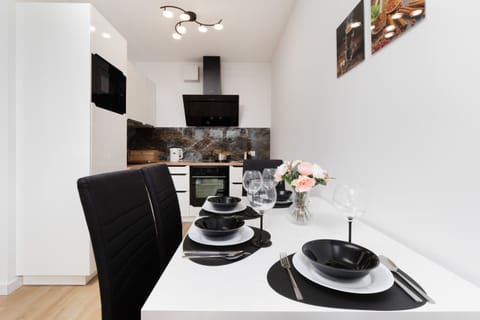 Dining area with a modern black-and-white theme, set up for an elegant dining experience.
