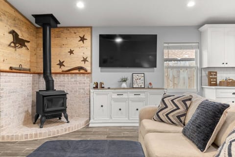 Warm and inviting living space — gather around the wood-burning stove, enjoy rustic charm