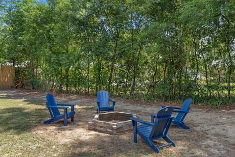 Relax under the trees — gather around the fire pit in comfy Adirondack chairs for cozy evenings