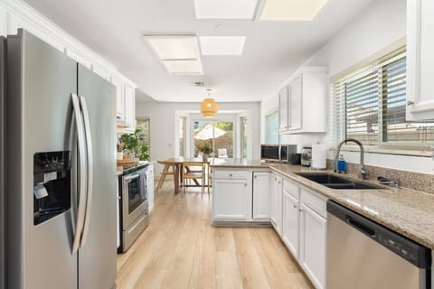 Prep and entertain! Open view to indoor dining area and sunny backyard patio.