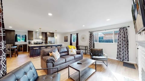 A bright and inviting living space featuring a cozy fireplace, modern decor, and ample seating, perfect for relaxation and entertainment.
