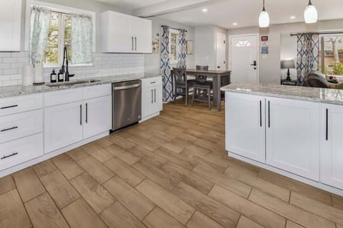 The kitchen is meticulously clean and well-maintained, with spotless countertops, organized cabinets, and gleaming appliances, ensuring a fresh and welcoming environment for meal preparation.