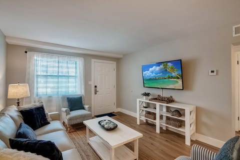 Welcome to Venus 106 - The Salty Sister! Sink into plush seating while your favorite shows play on the large screen TV in this bright, coastal-themed living space.