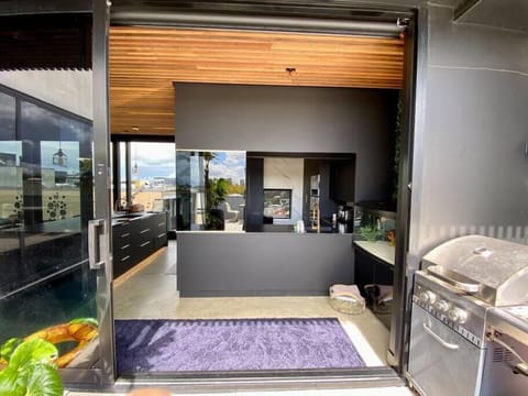 The dual sink kitchen offers a servery to the pool deck, or help yourself to bar b q instead.
