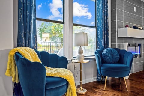 Inviting Sunlit Hallway: Bathed in warm sunlight streaming through a picturesque window, this welcoming hallway features stylish accent chairs, creating a comfortable and inviting atmosphere. (Keywords: hallway, sunlit, window, accent chairs, invitin