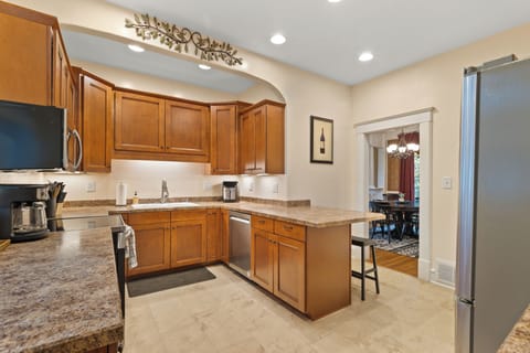 Fully stocked kitchen area w/ 2 bar stools 