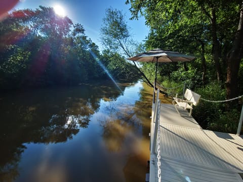 Tranquil river dock: cozy bench, gentle light.