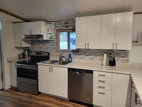 Kitchen with lots of cooking utensils and appliances