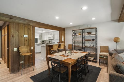 Dining room area along with a smaller bar with stools
