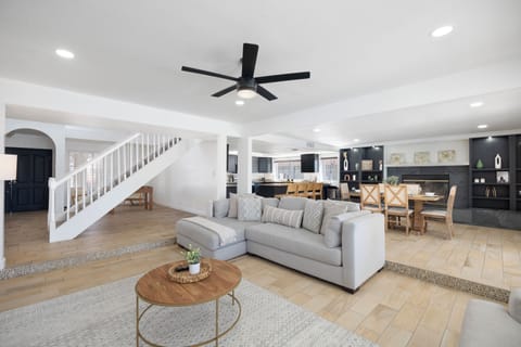 Modern open living: cozy seating, group dining, and seamless flow to kitchen.