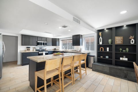 Full kitchen plus stylish, illuminated built-in shelving.