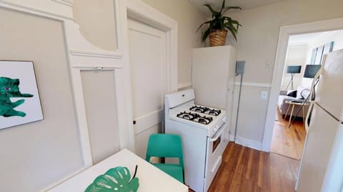 Kitchen with table and gas stove.