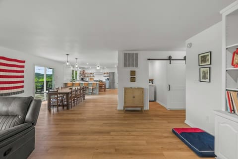 Living room with dog bed looking into dining area and kitchen.