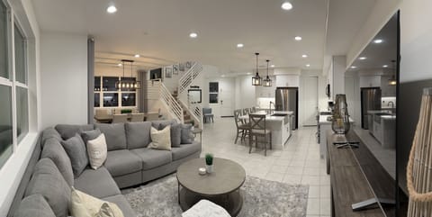 Living room with 75” Smart TV, kitchen with all amenities