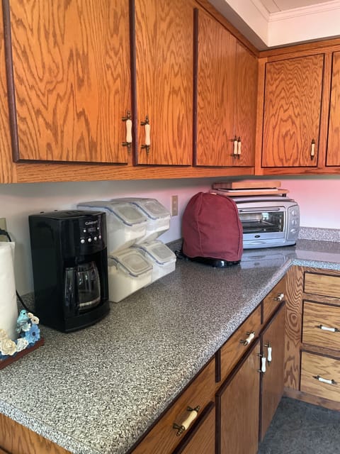 There is a coffee maker, mixer, and toaster oven.
