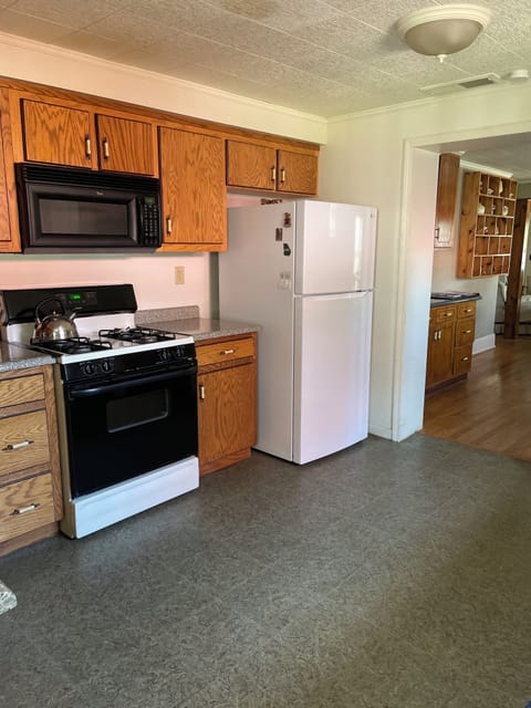 The kitchen has a gas stove and refrigerator with ice maker.