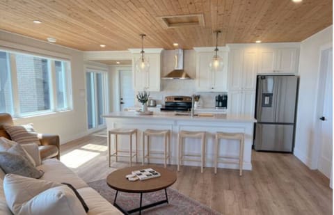 Open concept living and dining area with large windows looking out to Lake Erie.