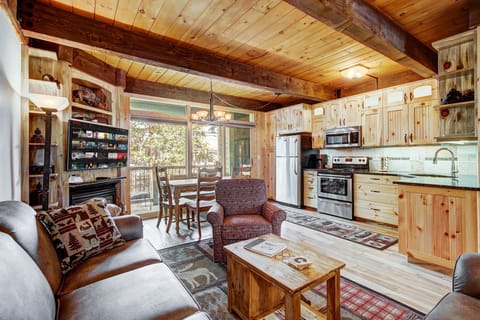 Relax and unwind in the cozy living room with a charming fireplace.
