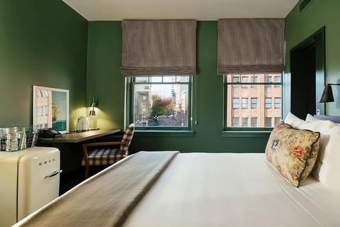 Stretch out on a plush bed in a serene corner room.