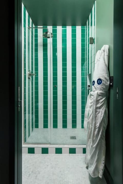 Step into a bright walk-in shower for an energizing start.