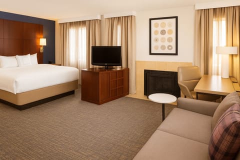 Unwind in a spacious suite with fireplace and cozy seating.