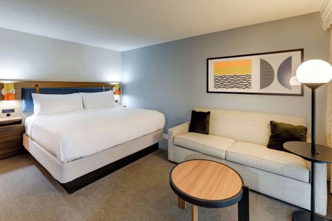 Unwind on plush linens beside a cozy sofa retreat.