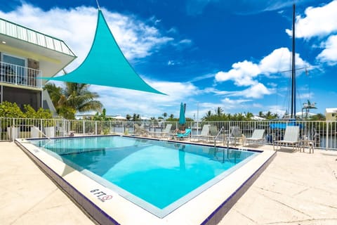 Take a refreshing dip in the pool or unwind on a lounge chair, overlooking the tranquil canal.