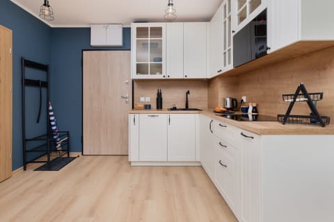 A wide-angle shot of the modern kitchen area, equipped with high-quality appliances and a spacious countertop.

