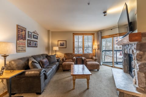 Living area offering cozy furnishings, a gas fireplace and smart TV.