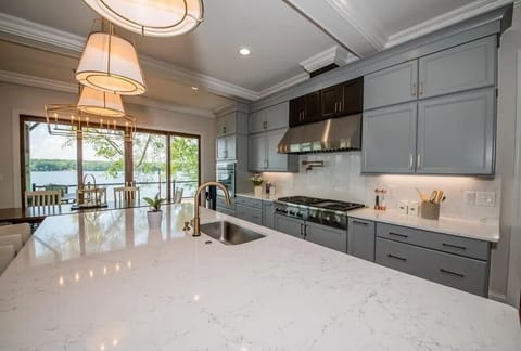 Thermador gas range, refrigerator, and appliances. Plus, pot filler, touch kitchen faucet, massive island workstation. Truly a chef's dream kitchen.