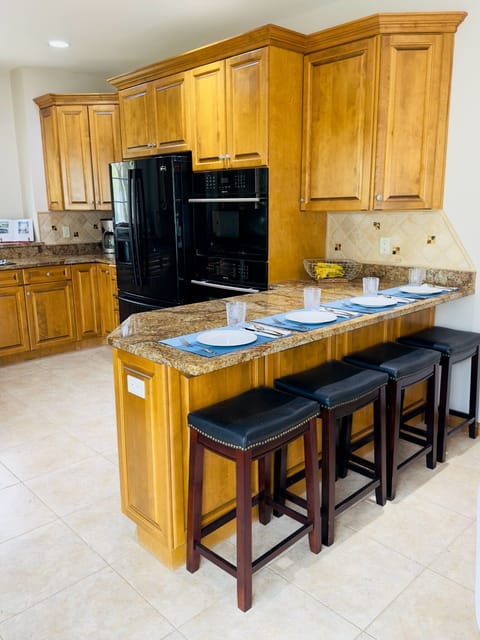 Kitchen with dining area and 4 barstools