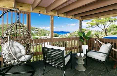 Relax on the deck with stunning ocean views and cozy seating. Perfect for a serene island getaway!