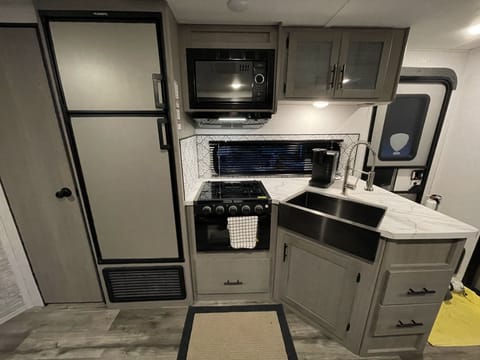 Kitchen with microwave, stove and oven