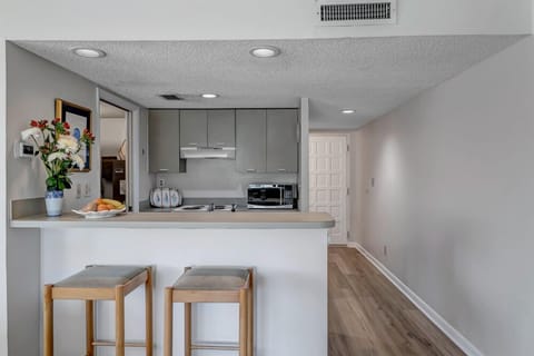 - Dine in style at this minimalist breakfast bar with comfortable stools and open layout
- Bright lighting and neutral tones create a clean, airy atmosphere
- Perfect for snacks, drinks, or connecting with guests while cooking