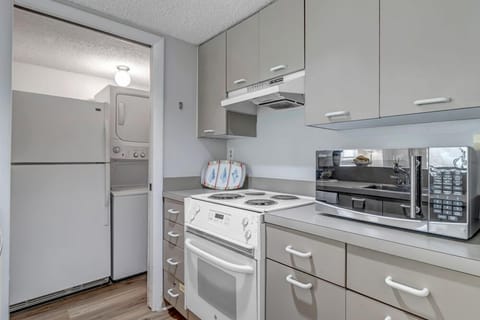 - Whip up meals with ease in this efficient galley kitchen with full size appliances
- Oven, cooktop, microwave, and stacked laundry make this space ultra functional
- Compact, stylish setup that doesn’t miss a thing