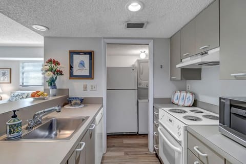 - Stay connected while you cook thanks to the pass-through counter and open design
- Stainless sink, electric stove, and modern cabinetry keep everything tidy and bright
- All essentials ready for short stays or longer visits