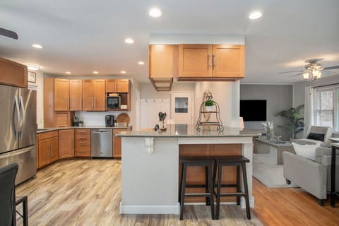 Seamless flow between kitchen, counter dining, and living room for effortless gatherings.