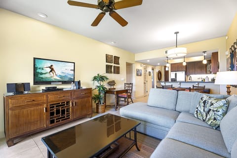 The interior is adorned with tile flooring, tropical brown granite countertops, tiled showers, and modern stainless steel kitchen appliances.