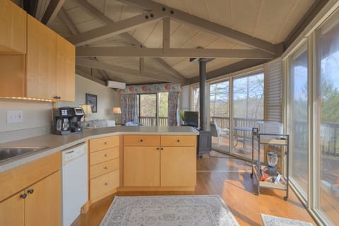 Kitchen view leading to the living area where you will love watching the sunset through the large windows!