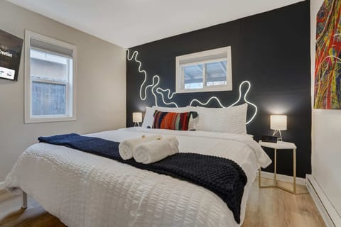 Experience Blissful Slumber on our King Bed with Plush Mattress, Crisp Linens, Snug Pillows, and Soft Blankets. Enjoy the Added Convenience of Bedside Lamps and Thoughtful Amenities, including Towels, for Your Ultimate Comfort!