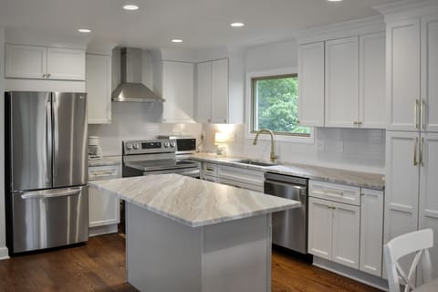 Large eat-in kitchen offers new, soft-closed cabinetry and new appliances.