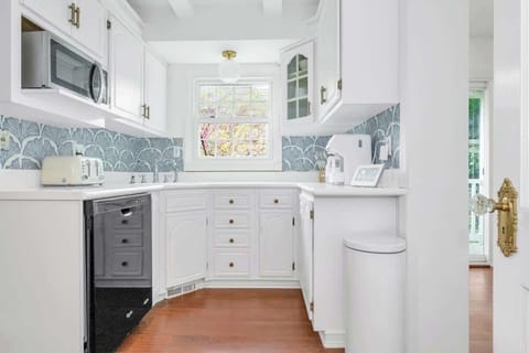 Full stocked kitchen with dishwasher, microwave, fridge and stove.